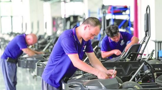 Technicians assembling a kart chassis